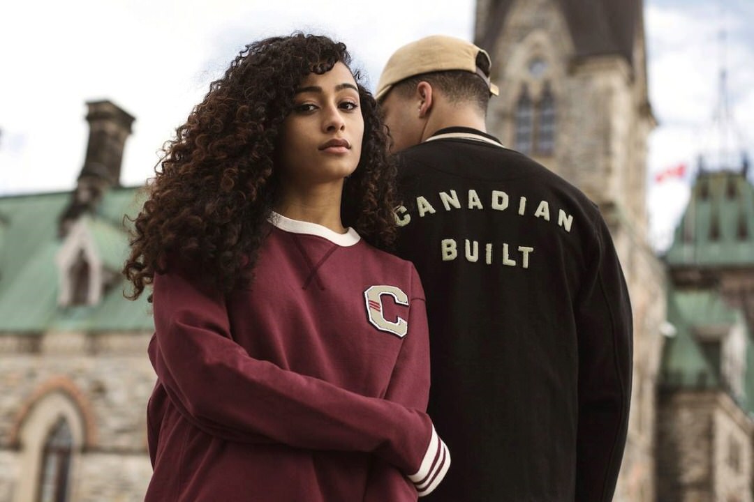 A woman and a man in front of a building