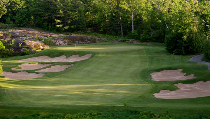 Lush, green fairway at a scenic golf course.